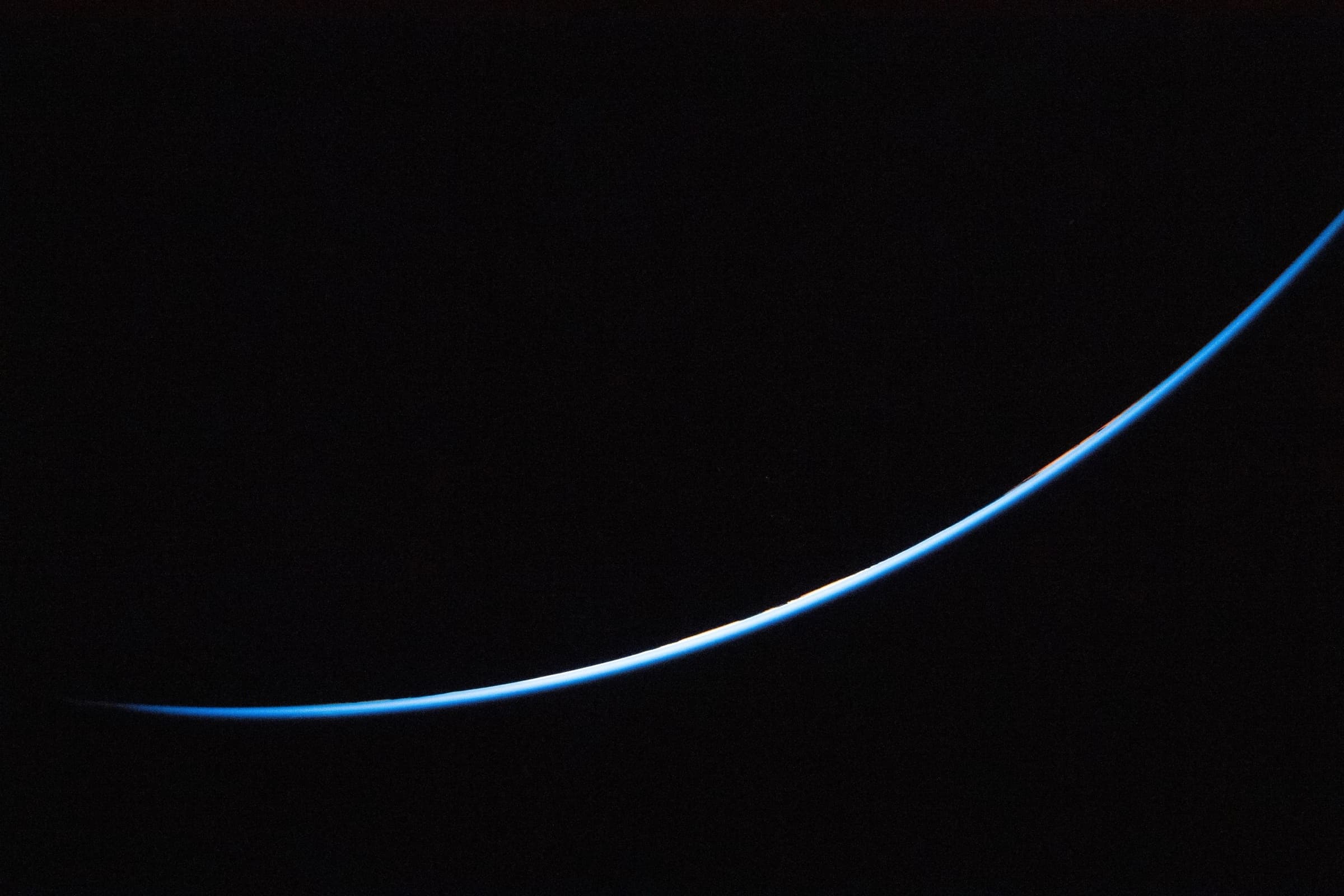 Earth's atmospheric limb glowing against the black of space